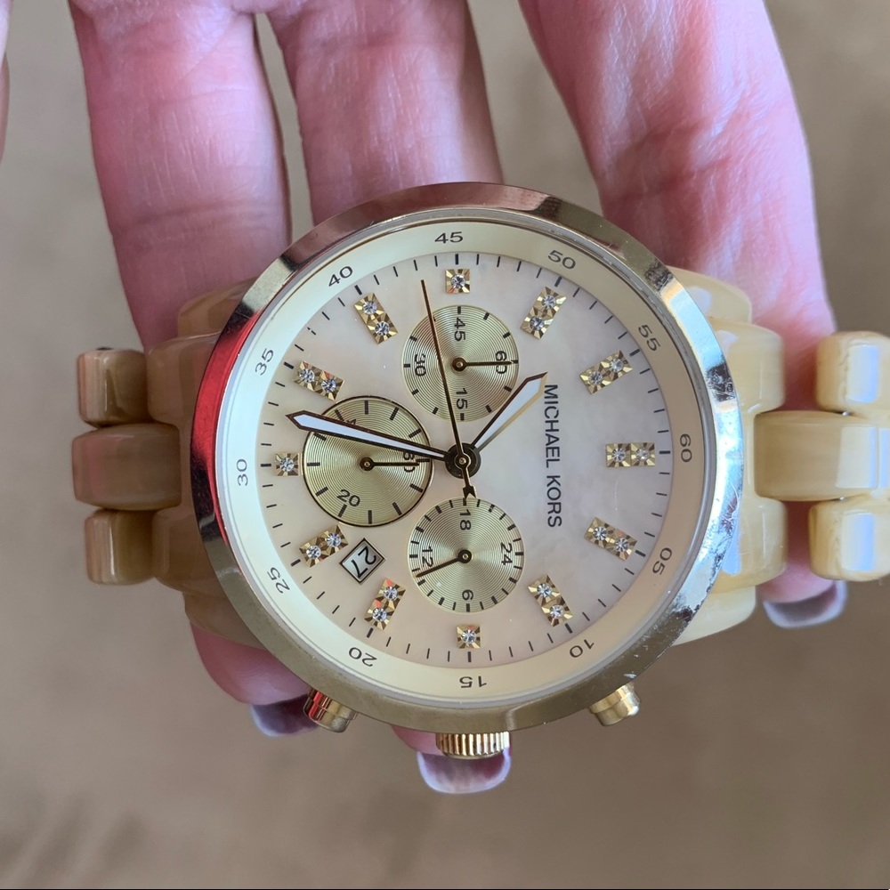Gold Michael Kors women’s watch with extra links